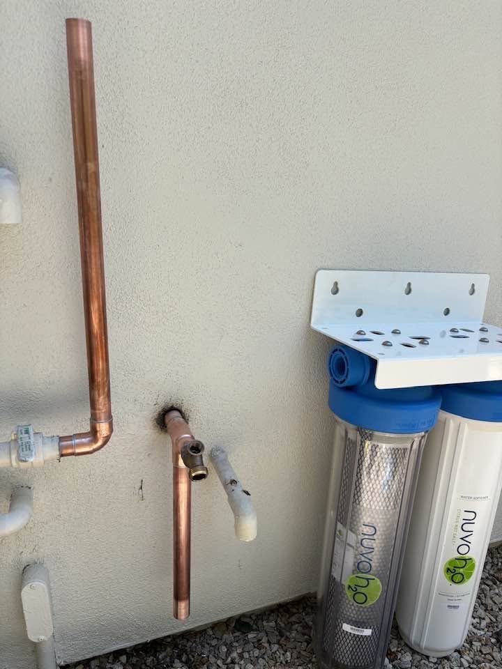 NuvoH2O water-conditioning equipment beside copper and PVC piping